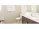 Well-lit bathroom featuring a modern vanity, toilet, and a window providing natural light at 16515 N Comet Trl, Maricopa, AZ 85138