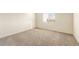 Bedroom featuring neutral walls, plush carpeting, and large window for plenty of natural light at 16515 N Comet Trl, Maricopa, AZ 85138