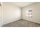 Bright and spacious bedroom with neutral walls, large window, and plush carpeting at 16515 N Comet Trl, Maricopa, AZ 85138