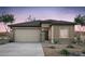 Charming single-story home featuring a neutral color palette, desert landscaping, and attached two-car garage at 16515 N Comet Trl, Maricopa, AZ 85138