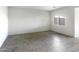 Large living room with tile floor, neutral paint, and a window at 16555 N Comet Trl, Maricopa, AZ 85138