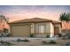 Charming single-story home featuring a two-car garage, neutral color palette and desert landscaping at 16565 N Comet Trl, Maricopa, AZ 85138