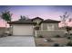 Charming single-story home featuring a desert landscape, tile roof, and a two-car garage at 16575 N Comet Trl, Maricopa, AZ 85138