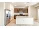 Bright kitchen featuring stainless steel appliances, granite countertops, and tile flooring at 16575 N Comet Trl, Maricopa, AZ 85138