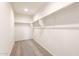 Spacious walk-in closet with neutral carpet, shelving, and ample storage space at 16575 N Comet Trl, Maricopa, AZ 85138