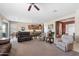 Open-concept living room flowing into the kitchen, complete with plush seating and ample space at 17642 W Verdin Rd, Goodyear, AZ 85338