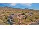 Expansive aerial view of a Southwestern-style home nestled in a desert landscape with mountain views at 17991 N 95Th St, Scottsdale, AZ 85255