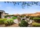 Scenic backyard featuring a firepit, seating area, privacy landscaping, and beautiful desert mountain views at 17991 N 95Th St, Scottsdale, AZ 85255