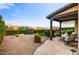 Expansive backyard with mature landscaping, a covered patio, and views of the mountains in the distance at 17991 N 95Th St, Scottsdale, AZ 85255