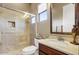 A modern bathroom features a glass-enclosed shower, updated vanity, and neutral color scheme at 17991 N 95Th St, Scottsdale, AZ 85255
