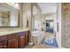 Bathroom featuring a large vanity, soaking tub, and an arched doorway leading to the bedroom at 17991 N 95Th St, Scottsdale, AZ 85255