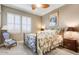 Cozy bedroom featuring a wrought iron bed, comfortable armchair, and traditional decor at 17991 N 95Th St, Scottsdale, AZ 85255