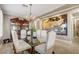Formal dining area with seating for eight, chandelier, and glass-topped table at 17991 N 95Th St, Scottsdale, AZ 85255
