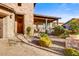 Welcoming front entrance with a wood door, stone accents, and manicured landscaping creating curb appeal at 17991 N 95Th St, Scottsdale, AZ 85255