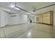 Spacious three-car garage with ample storage cabinets and overhead racks, maximizing organization and functionality at 17991 N 95Th St, Scottsdale, AZ 85255