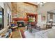 Inviting living room with a stone fireplace, built-in entertainment center, and ample seating for relaxation and entertainment at 17991 N 95Th St, Scottsdale, AZ 85255