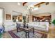 Spacious living room with high ceilings, abundant natural light, elegant furnishings, and seamless flow into kitchen at 17991 N 95Th St, Scottsdale, AZ 85255
