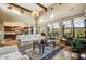 Open-concept living room featuring high ceilings, large windows with scenic views, and comfortable seating at 17991 N 95Th St, Scottsdale, AZ 85255
