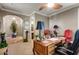 Cozy office with a vintage desk and decor, features two chairs and an arched entry at 17991 N 95Th St, Scottsdale, AZ 85255