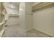 Spacious walk-in closet featuring shelving and ample storage space for organizing clothes and accessories at 17991 N 95Th St, Scottsdale, AZ 85255