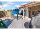 Relaxing backyard offering a covered hot tub, concrete patio, and well-maintained landscaping, perfect for unwinding at 1801 E Hearn Rd, Phoenix, AZ 85022
