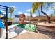 Spacious backyard showcasing a custom play structure, shed, and mature trees ideal for Gathering fun at 1801 E Hearn Rd, Phoenix, AZ 85022