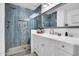 Modern bathroom featuring a glass enclosed shower and white vanity with drawers at 1801 E Hearn Rd, Phoenix, AZ 85022