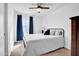 Bedroom featuring a queen sized bed, carpet flooring, and a window with dark blue curtains at 1801 E Hearn Rd, Phoenix, AZ 85022