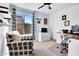 Cozy bedroom featuring a ceiling fan, large window and a dedicated desk area perfect for working at home at 1801 E Hearn Rd, Phoenix, AZ 85022