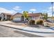 Street view of a well-kept home with desert landscaping and a two-car garage at 1801 E Hearn Rd, Phoenix, AZ 85022