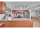 Open kitchen area with stainless steel appliances, wood cabinetry and a skylight at 1801 E Hearn Rd, Phoenix, AZ 85022