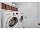 Well-equipped laundry room with modern LG washer and dryer, ample shelving, and a convenient storage area at 1801 E Hearn Rd, Phoenix, AZ 85022