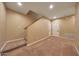 Carpeted basement area with staircase, and access to storage space at 2050 N 144Th Dr, Goodyear, AZ 85395