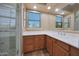 Bathroom with light tile floors, a window, and a frameless glass shower enclosure at 2050 N 144Th Dr, Goodyear, AZ 85395