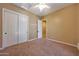 Neutral bedroom with carpet, ceiling fan, and spacious closet at 2050 N 144Th Dr, Goodyear, AZ 85395