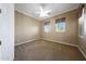 A comfortable bedroom featuring neutral carpet flooring and two windows at 2050 N 144Th Dr, Goodyear, AZ 85395