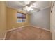 Bedroom with carpet, ceiling fan, and natural light from the large window at 2050 N 144Th Dr, Goodyear, AZ 85395
