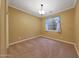 Bedroom featuring neutral walls, carpet flooring, and a window with shades at 2050 N 144Th Dr, Goodyear, AZ 85395