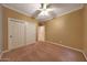 Bedroom with neutral color, carpet flooring, and ceiling fan at 2050 N 144Th Dr, Goodyear, AZ 85395