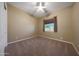 Neutral bedroom showcasing plush carpet and a sun-filled window with blinds at 2050 N 144Th Dr, Goodyear, AZ 85395