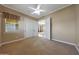 Bright bedroom with a ceiling fan, neutral paint, and an attached bathroom at 2050 N 144Th Dr, Goodyear, AZ 85395