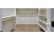 Walk-in closet with carpeted floors and built-in shelving and racks at 2050 N 144Th Dr, Goodyear, AZ 85395