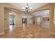 Open dining space features a decorative chandelier, archways, and tiled floors at 2050 N 144Th Dr, Goodyear, AZ 85395