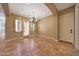 Dining area with tiled floor, chandelier, and access to the backyard through French doors at 2050 N 144Th Dr, Goodyear, AZ 85395