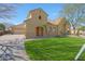 Charming home with lush green lawn, desert landscaping, three car garage and a tile roof at 2050 N 144Th Dr, Goodyear, AZ 85395