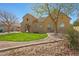 Charming home with lush green lawn, desert landscaping and a tile roof at 2050 N 144Th Dr, Goodyear, AZ 85395