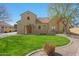 Charming home with lush green lawn, desert landscaping and a tile roof at 2050 N 144Th Dr, Goodyear, AZ 85395