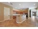 Kitchen featuring wood cabinets, breakfast bar, and stainless steel appliances at 2050 N 144Th Dr, Goodyear, AZ 85395