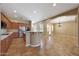 Well-lit kitchen with stainless steel appliances and an open layout to the living room at 2050 N 144Th Dr, Goodyear, AZ 85395