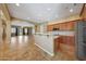 Open-concept kitchen with bar, tiled floor and stainless steel appliances at 2050 N 144Th Dr, Goodyear, AZ 85395